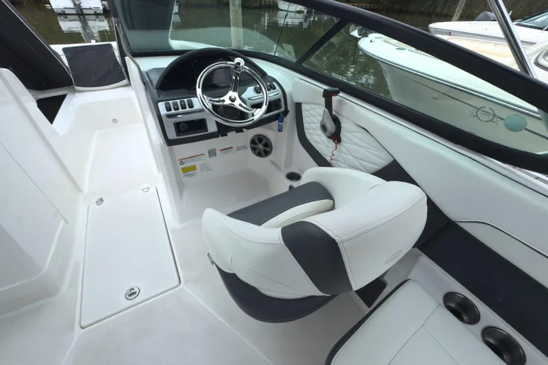 Slide: The Image of Interior view of 2022 Regal 23 OBX boat, featuring steering wheel and seating. - 19