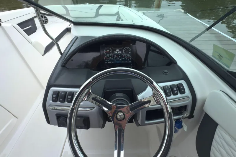Slide: The Image of 2022 Regal 23 OBX boat dashboard with steering wheel and control panel. - 20