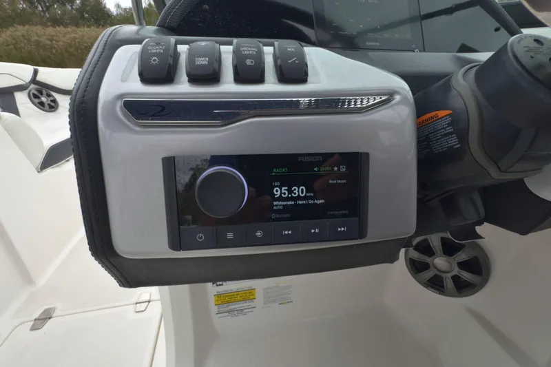 Slide: The Image of Dashboard of 2022 Regal 23 OBX boat with radio and control switches. - 22
