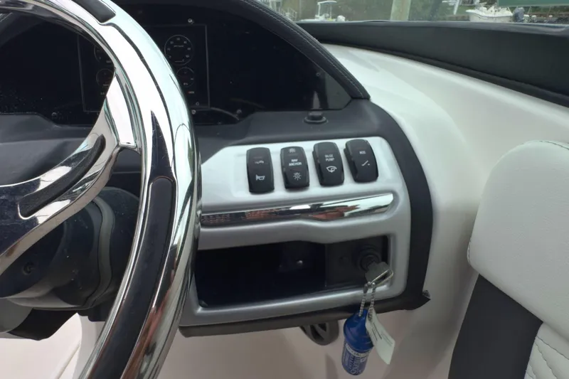 Slide: The Image of Dashboard of 2022 Regal 23 OBX boat with steering wheel and control panel. - 23
