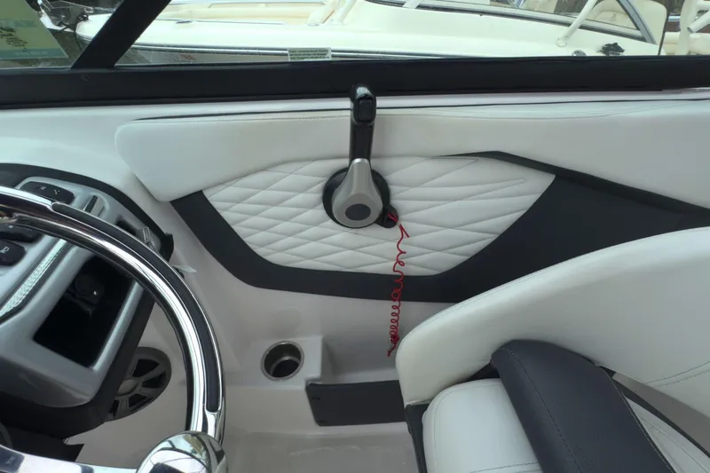 Slide: The Image of Interior of 2022 Regal 23 OBX boat, featuring steering wheel and quilted panel design. - 24