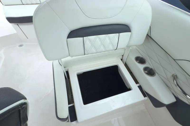 Slide: The Image of 2022 Regal 23 OBX boat seat with storage compartment and cup holders. - 28