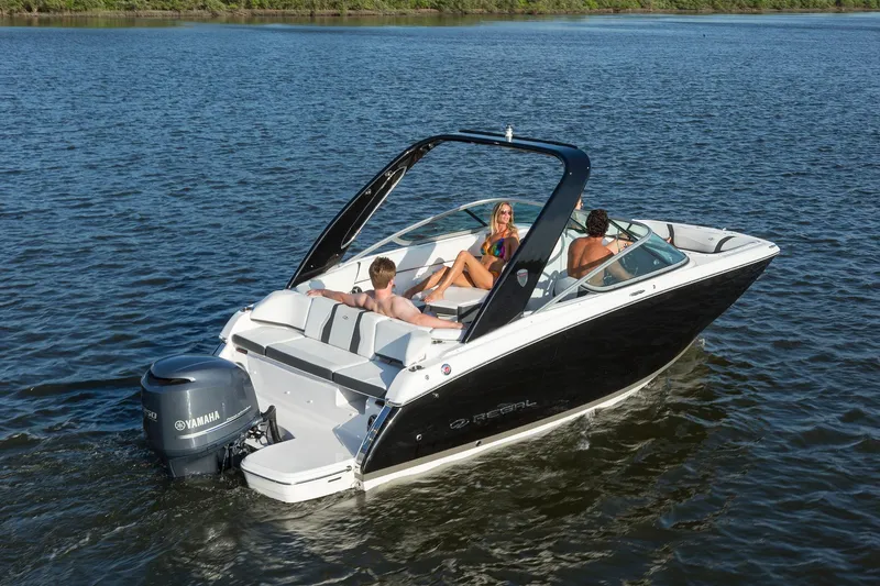 Slide: The Image of 2022 Regal 23 OBX boat cruising on a calm lake with scenic background. - 3