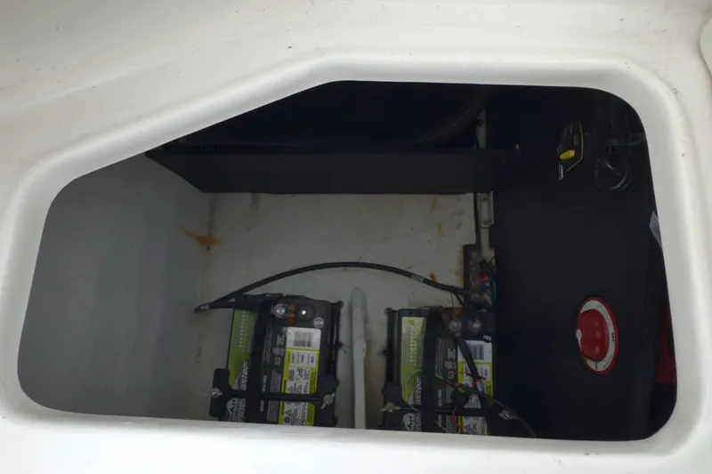 Slide: The Image of Battery compartment of 2022 Regal 23 OBX boat, featuring dual batteries and wiring. - 38