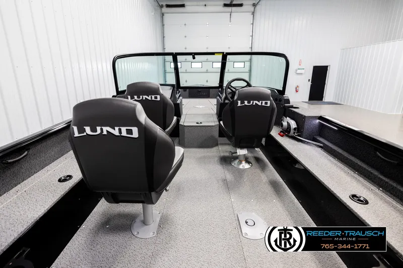 Slide: The Image of 2026 Lund 1800 Explorer Sport boat interior with branded seats in a showroom. - 11