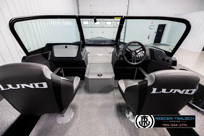 Slide: The Image of Interior view of 2026 Lund 1800 Explorer Sport boat with dual seats and steering console. - 12