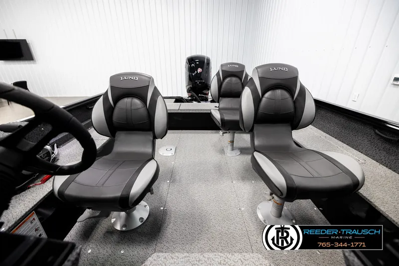 Slide: The Image of 2026 Lund 1800 Explorer Sport boat interior with three black and gray seats. - 15