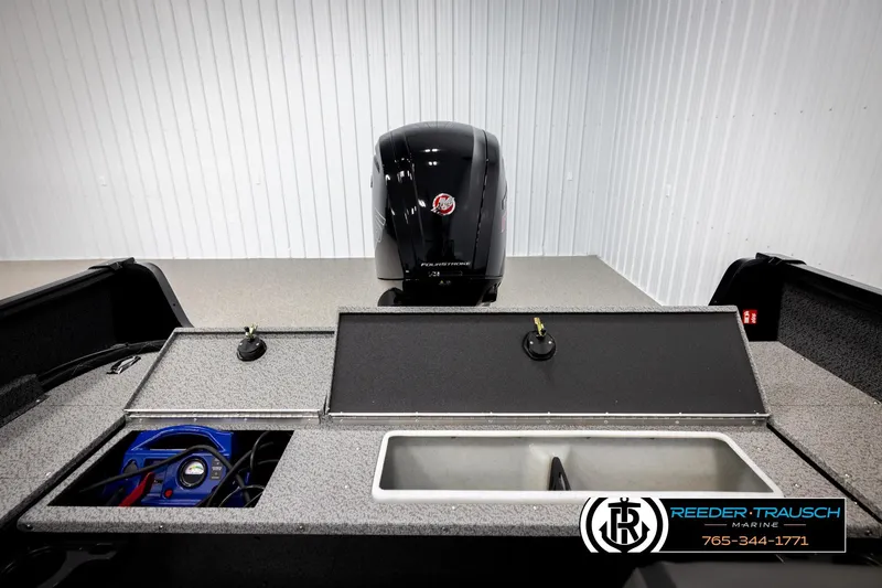 Slide: The Image of 2026 Lund 1800 Explorer Sport boat interior with storage compartments and motor, Reeder-Trausch Marine. - 17