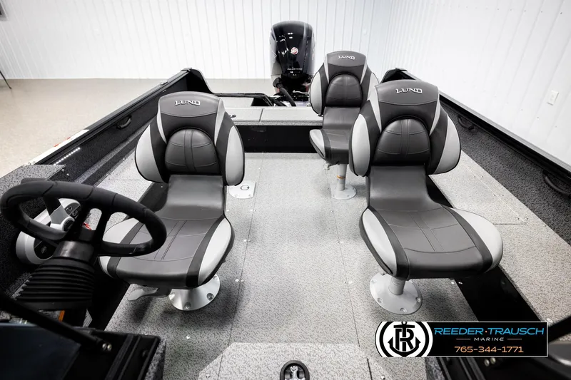 Slide: The Image of 2026 Lund 1800 Explorer Sport boat interior with four gray seats and steering wheel. - 21