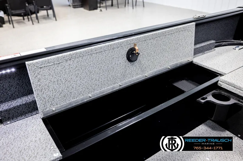Slide: The Image of 2026 Lund 1800 Explorer Sport boat interior storage compartment with carpeted finish. - 23