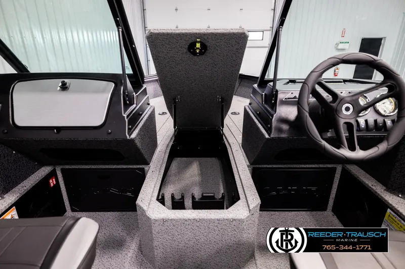 Slide: The Image of 2026 Lund 1800 Explorer Sport boat interior with steering wheel and storage compartment. - 25