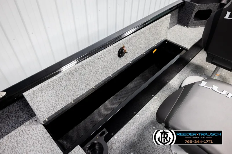 Slide: The Image of 2026 Lund 1800 Explorer Sport boat interior with storage compartment and seating. - 26