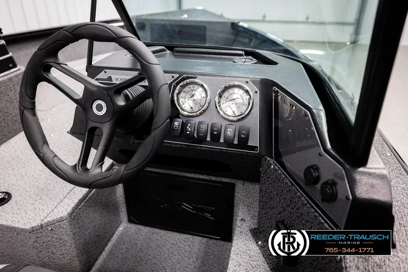 Slide: The Image of 2026 Lund 1800 Explorer Sport dashboard with steering wheel and gauges, Reeder-Trausch Marine branding. - 28