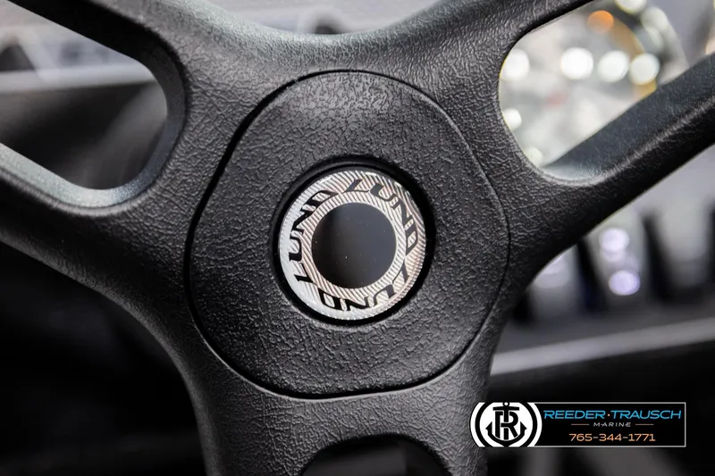 Slide: The Image of Steering wheel of 2026 Lund 1800 Explorer Sport boat, featuring textured grip. - 30