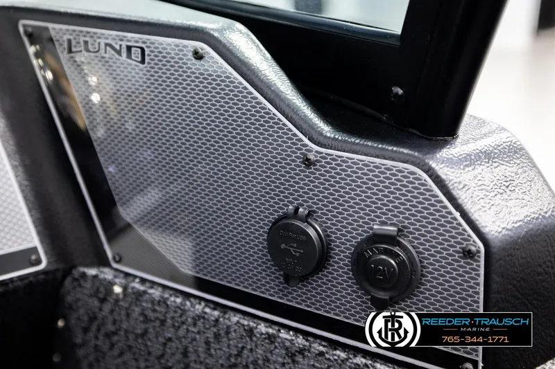 Slide: The Image of 2026 Lund 1800 Explorer Sport interior detail with dual USB and 12V outlets. - 32