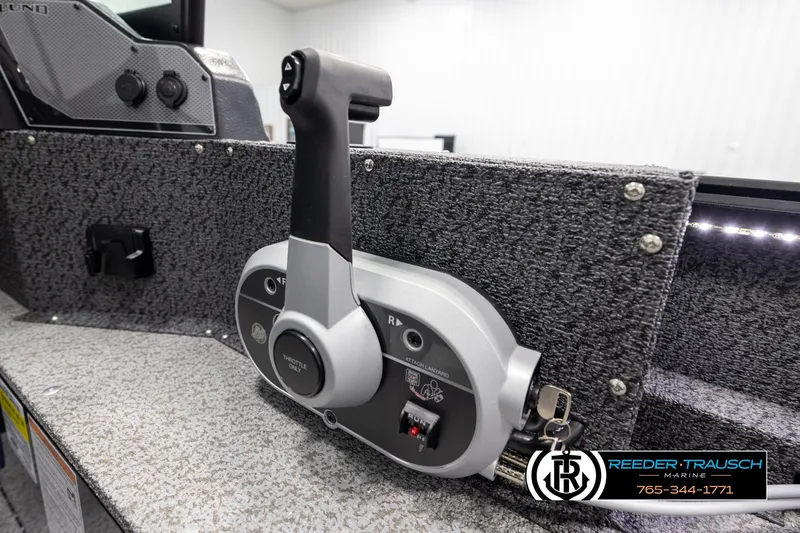 Slide: The Image of Throttle control panel of 2026 Lund 1800 Explorer Sport boat, featuring ergonomic design. - 34