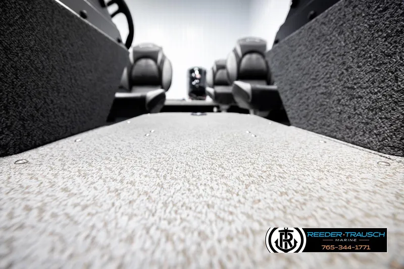 Slide: The Image of 2026 Lund 1800 Explorer Sport interior with textured flooring and seating, Reeder-Trausch Marine logo. - 36