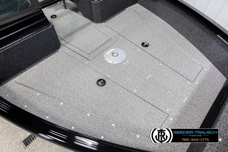 Slide: The Image of 2026 Lund 1800 Explorer Sport boat interior with textured flooring and storage compartments. - 7