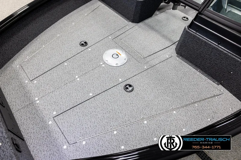 Slide: The Image of 2026 Lund 1800 Explorer Sport boat interior with gray carpeted deck and storage compartments. - 8