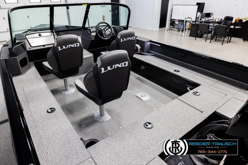 Slide: The Image of 2026 Lund 1800 Explorer Sport boat interior with three seats in showroom. - 9