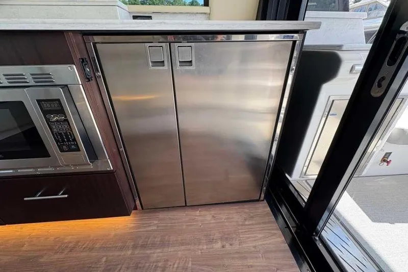 Slide: The Image of Modern kitchen area in 2019 Regal 42 Fly yacht with stainless steel appliances. - 12