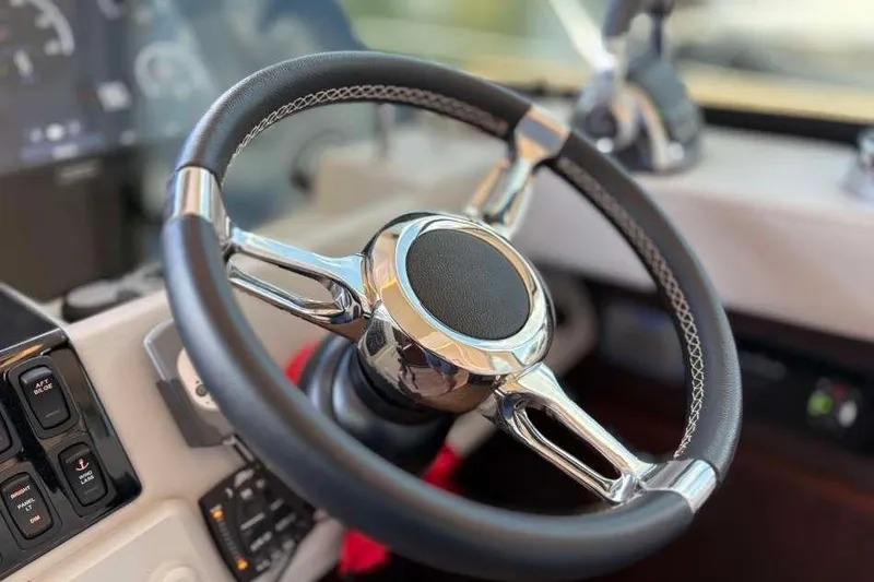 Slide: The Image of Steering wheel of 2019 Regal 42 Fly yacht, featuring sleek design and modern controls. - 15