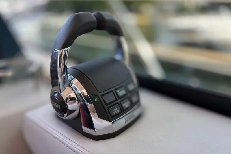 Slide: The Image of Close-up of 2019 Regal 42 Fly yacht throttle controls with buttons and chrome handles. - 16