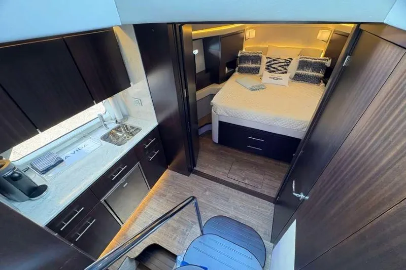 Slide: The Image of Luxurious interior of 2019 Regal 42 Fly yacht with modern kitchen and cozy bedroom. - 19