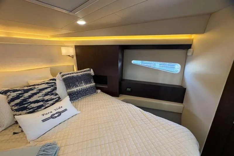 Slide: The Image of Luxurious bedroom interior of 2019 Regal 42 Fly yacht with elegant bedding and ambient lighting. - 21