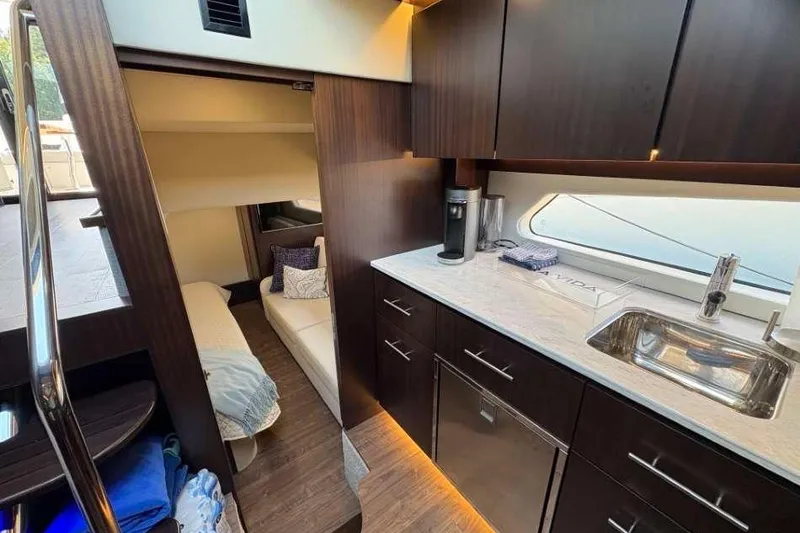 Slide: The Image of Luxurious interior of 2019 Regal 42 Fly yacht with modern kitchen and cozy cabin. - 22