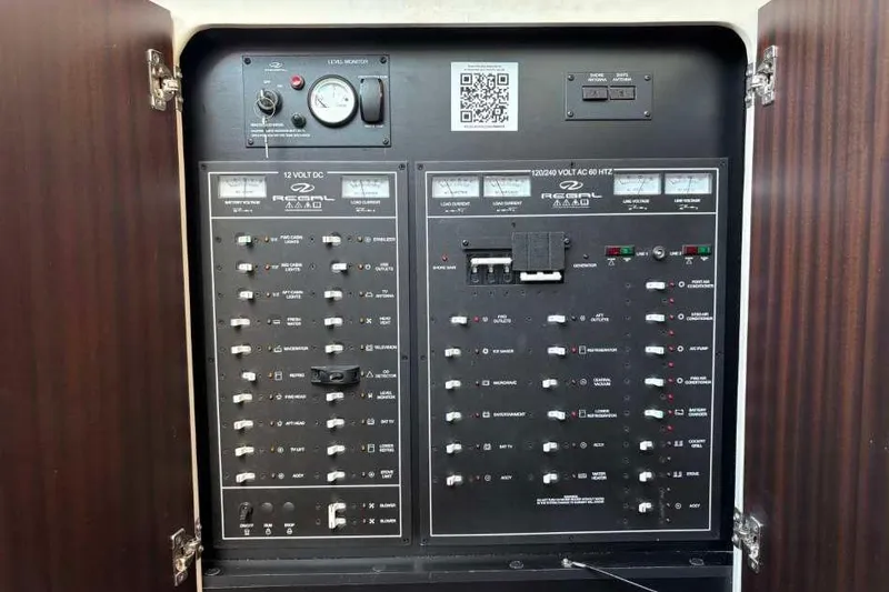 Slide: The Image of Electrical control panel of a 2019 Regal 42 Fly yacht, featuring various switches and gauges. - 24