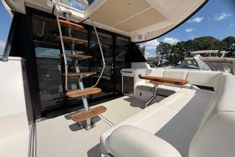 Slide: The Image of 2019 Regal 42 Fly yacht interior with elegant seating and wooden staircase. - 4