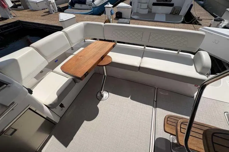 Slide: The Image of 2019 Regal 42 Fly yacht interior with white seating and wooden table. - 6