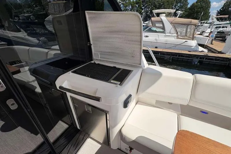 Slide: The Image of Outdoor grill and seating area on 2019 Regal 42 Fly yacht at marina. - 7