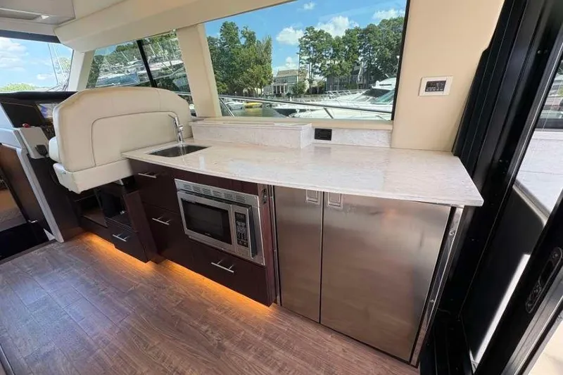 Slide: The Image of Luxurious interior of 2019 Regal 42 Fly yacht with modern kitchenette and sleek design. - 9