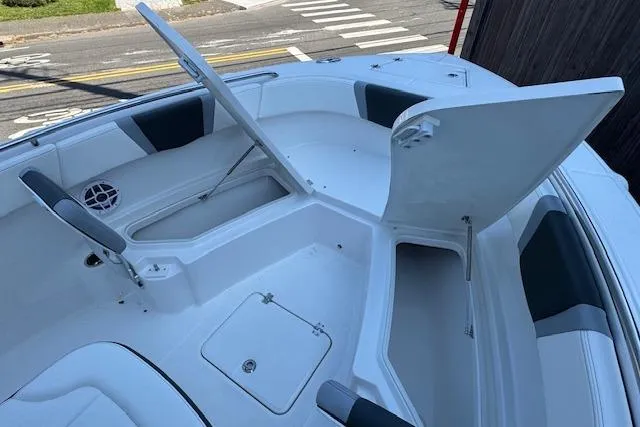 Slide: The Image of 2026 Robalo R230 Center Console boat with open storage compartments and seating. - 15