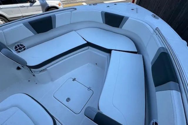 Slide: The Image of 2026 Robalo R230 Center Console boat interior with cushioned seating and storage. - 16