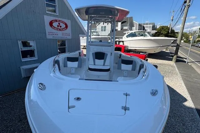 Slide: The Image of 2026 Robalo R230 Center Console boat displayed outdoors near a marina. - 3