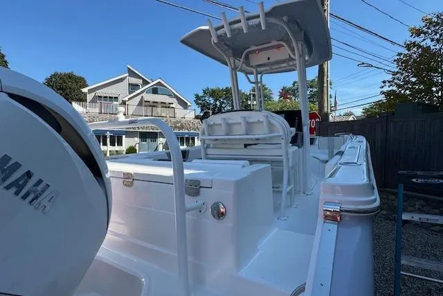 Slide: The Image of 2026 Robalo R230 Center Console boat with Yamaha engine, docked outdoors. - 4