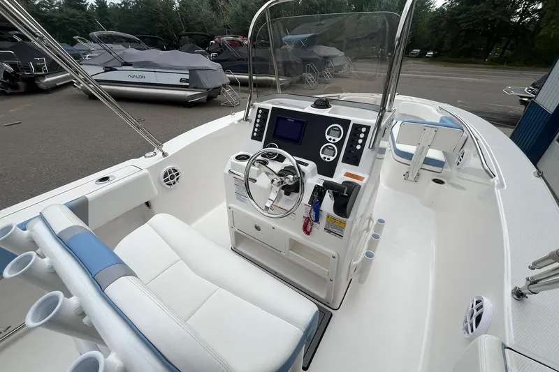 Slide: The Image of 2023 Robalo R200 Center Console boat interior with steering wheel and seating. - 27