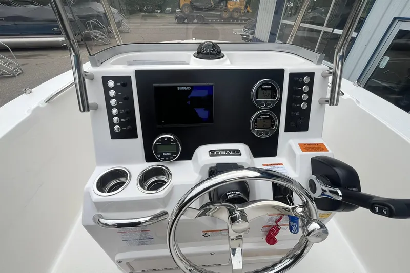 Slide: The Image of 2023 Robalo R200 Center Console dashboard with steering wheel and navigation controls. - 36