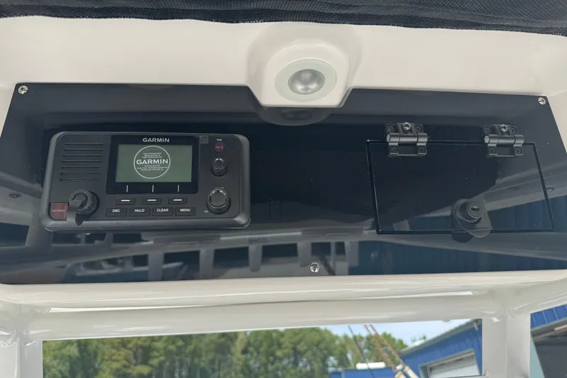 Slide: The Image of Garmin marine radio on 2026 Edgewater 230CC boat dashboard. - 18