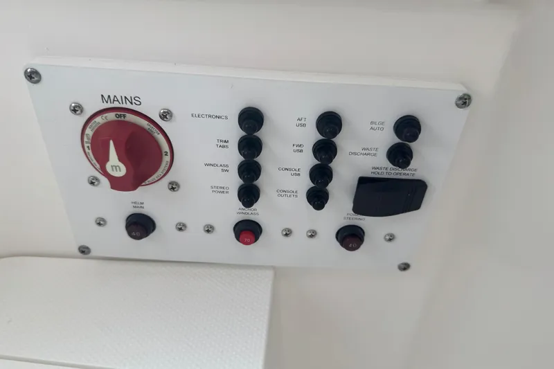 Slide: The Image of Control panel of 2026 Edgewater 230CC boat with various switches and dials. - 20
