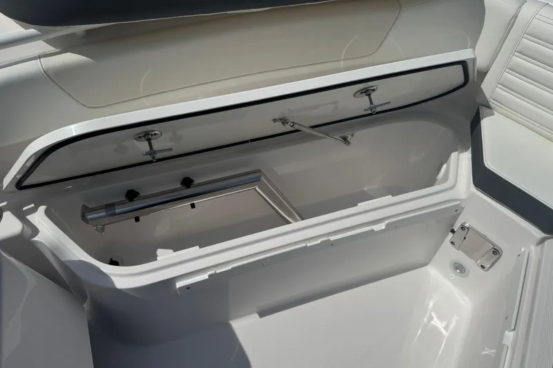 Slide: The Image of Open storage compartment in 2026 Edgewater 230CC boat, showcasing interior design and functionality. - 26
