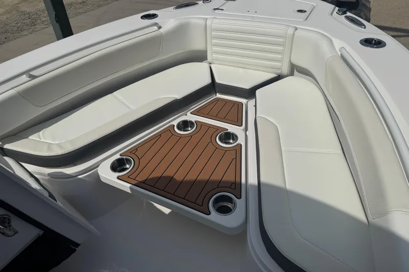 Slide: The Image of 2026 Edgewater 230CC boat interior with white seating and wood accents. - 27