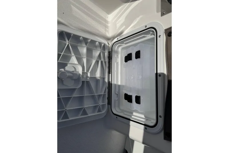 Slide: The Image of Open storage compartment on 2026 Edgewater 170CC boat, showcasing interior design. - 8