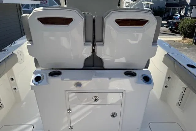 Slide: The Image of 2026 Pursuit S 268 Sport boat interior with dual seats and storage compartment. - 11