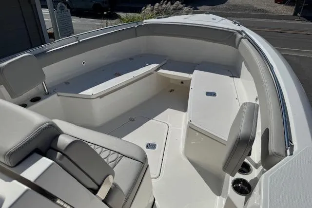 Slide: The Image of 2026 Pursuit S 268 Sport boat interior with cushioned seating and storage compartments. - 13