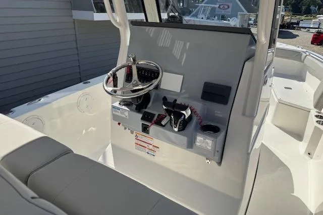 Slide: The Image of 2026 Pursuit S 268 Sport boat console with steering wheel and controls. - 3
