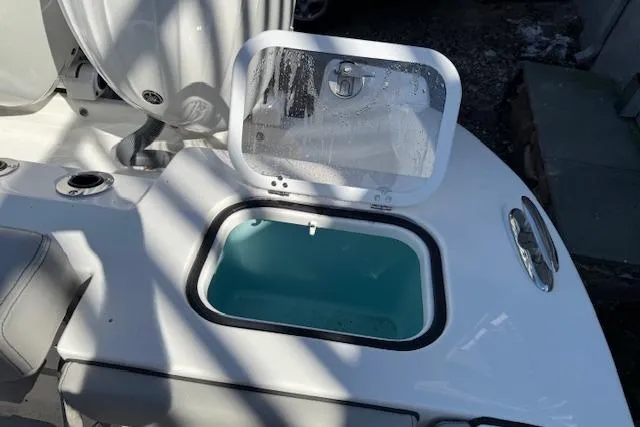 Slide: The Image of 2026 Pursuit S 268 Sport boat with open storage compartment and seating area. - 8